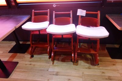 three chairs that are sitting in front of a window