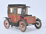 a small toy car with a man in the driver ' s seat