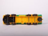 a yellow and green toy truck on a white surface