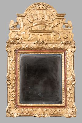 an image of a gold framed mirror on a gray wall