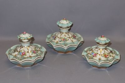 three pieces of blue and white porcelain with flowers on them