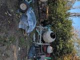 two cement mixers sitting next to each other on the side of the road