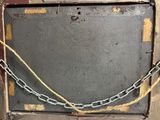 a metal box with a chain attached to it