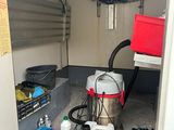 an image of a small room with a lot of stuff on the floor