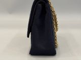 a black purse with a gold chain hanging from it