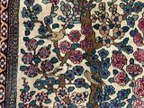 a close up of a rug with a tree of life on it