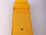 an image of a close up of a yellow object on a white surface