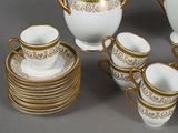 a lot of cups and saucers that are sitting on a table