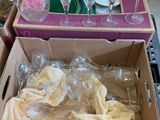 a box of empty wine glasses and a box of empty wine glasses on the floor
