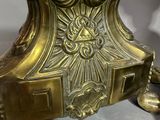 a gold clock sitting on top of a table