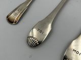 three spoons and two spoons on a table
