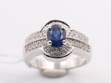 a close up of a sapphire and diamond ring on a white background
