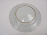 a white plate with a gold rim on a white table