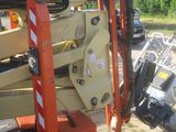 a crane that is sitting on the ground next to a pile of junk