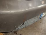 a close up of a car ' s bumper with a denting on it