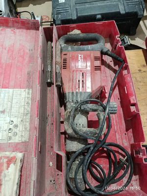 a red tool box with tools in it on the floor
