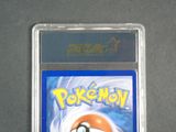 the card is in a clear plastic holder on a gray surface