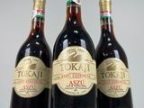 three bottles of liquor sitting on top of a white table
