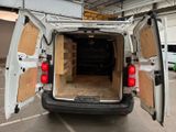 a white van with its doors open in a parking lot