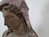 a statue of a woman with a hat on it ' s head