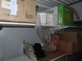 many boxes and packages on a shelf in a room