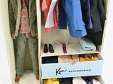 a doll that is standing inside of a suitcase