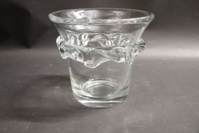 a glass vase with a handle on a table