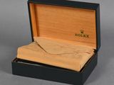 an image of a watch in a wooden box with a cloth in it