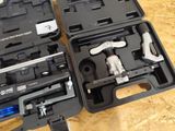 two black cases with tools in them on a table