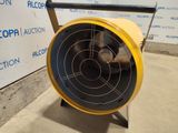 a yellow and black fan on a stand in front of a wall