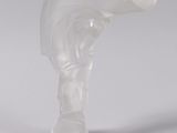 a clear glass sculpture of a man ' s head on a white surface