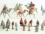 many figurines of people riding on horses and horses