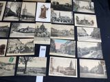many pictures of old buildings on display on a table