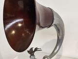 a silver and brown horn sitting on a table