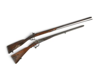 a pair of two guns are shown on a white surface