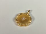 an image of a gold locke with a diamond in the center