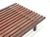 a close up of a wooden bench on a white surface