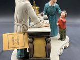 a figurine of a man and a woman with a child