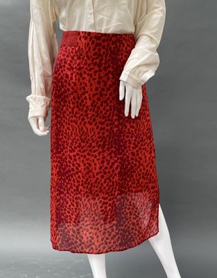 an image of a mannequin wearing a red leopard print skirt
