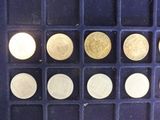 several different types of coins are arranged in a blue tray