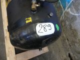 a black air compressor sitting on top of a wooden pallet