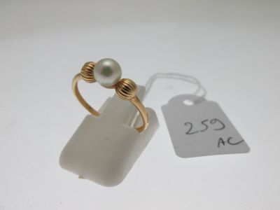 a ring with a pearl on it and a price tag