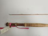 a fishing rod and a fishing pole on a white surface