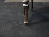 a black table with a white top and a black base
