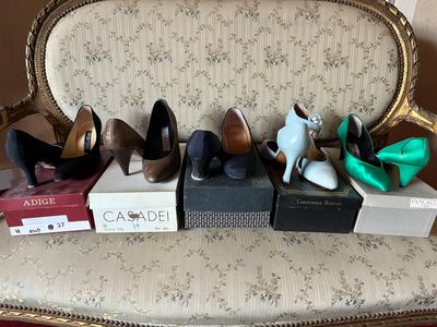 several pairs of women ' s shoes are lined up on a chair