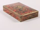 a red and gold box on a white surface