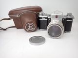 a camera and a coin sitting on a table