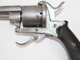 a gun that is sitting on a white surface