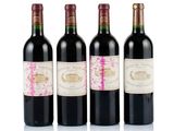 three bottles of wine are lined up in a row on a white surface