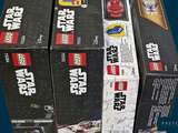 several boxes of lego star wars toys are stacked on top of each other